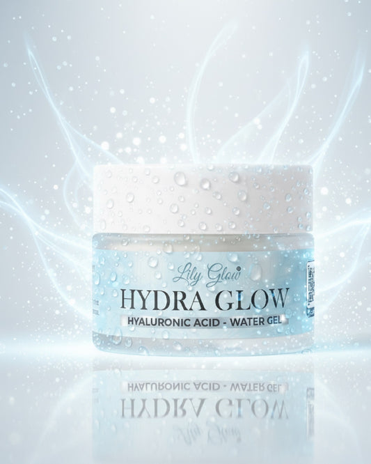 A jar of Lily Glow Hydra Glow Hyaluronic Acid Water Gel centered on a reflective white surface, with icy blue water droplets, glowing light streaks, and a soft white background.